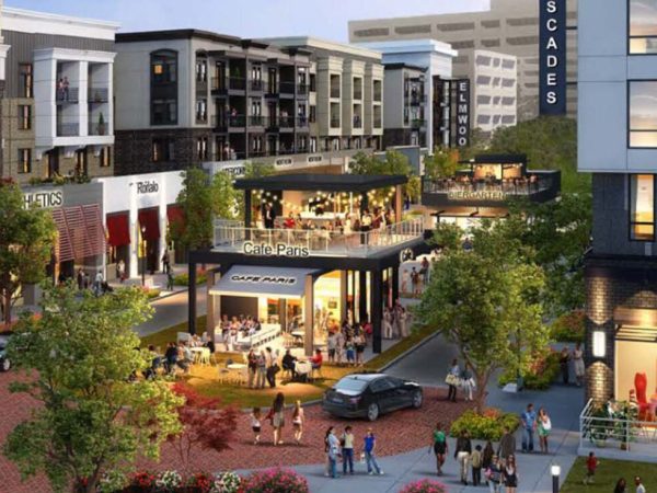 Artist rendering of a modern mixed-use development in Cockrum, MS, featuring cafes like “Cafe Paris,” retail shops, and multi-story apartments — highlighting future-ready electrical planning.