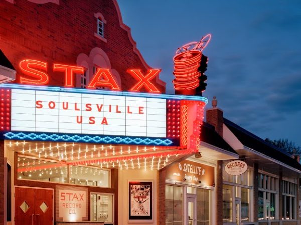 The iconic Stax Museum at dusk, illuminated by vibrant red neon signage reading “STAX SOULSVILLE USA,” symbolizing the heart of Shelby County’s music heritage.