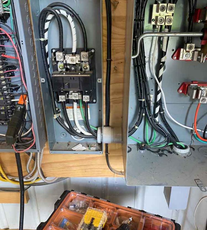 Electrical panel installation showing circuit breakers, wiring and power distribution components