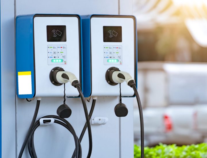 Dual EV charging stations with cables and connectors mounted outdoors
