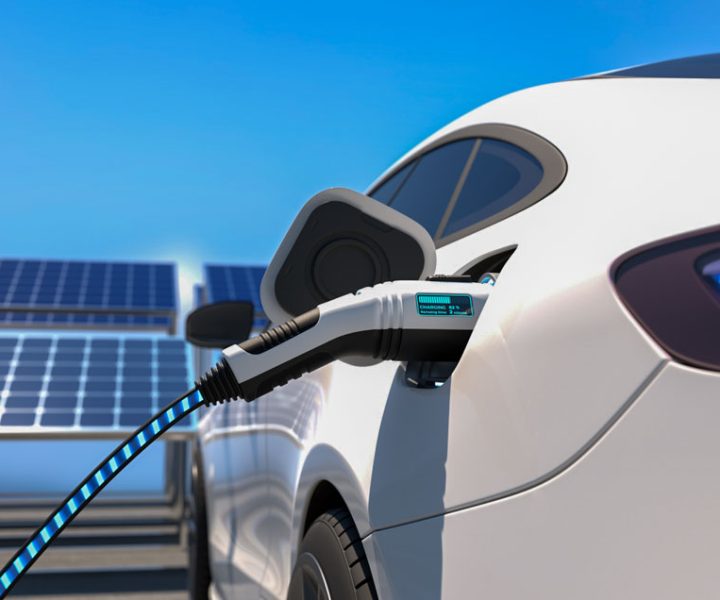 Electric car power charging, solar panel arrays on the background