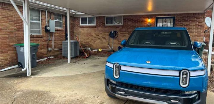 blue electric car parked on the garage