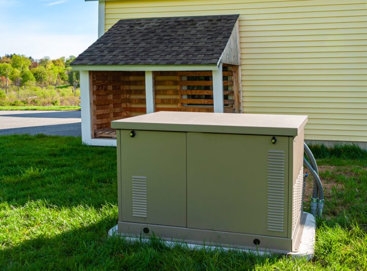 residential standby generator at the side of a house